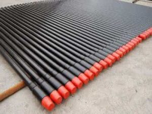 Water well drill rod with red protection caps